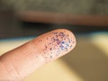 Hand with blue glittering brocade close up. Working crafts.