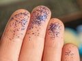 Hand with blue glittering brocade close up. Working crafts.