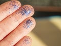 Hand with blue glittering brocade close up. Working crafts.