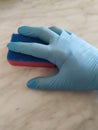 Hand in blue glove holding dish washing sponge make cleaning Royalty Free Stock Photo