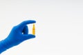 Hand in a blue glove holding medical ampule Royalty Free Stock Photo