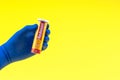 Hand in a blue glove holding multivitamin bottle Royalty Free Stock Photo