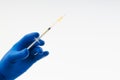 Hand in a blue glove holding syringe Royalty Free Stock Photo