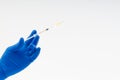 Hand in a blue glove holding syringe Royalty Free Stock Photo