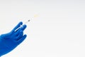 Hand in a blue glove holding syringe Royalty Free Stock Photo