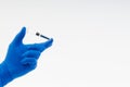 Hand in a blue glove holding syringe Royalty Free Stock Photo