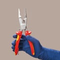 Hand in blue glove holds open pliers electrician Royalty Free Stock Photo