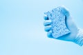 Hand in blue glove with sponge Royalty Free Stock Photo