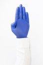 Hand in blue latex Glove. Stop sign. White background Royalty Free Stock Photo