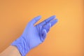 A hand with blue latex medic (medical) glove on it on a contrast background Royalty Free Stock Photo