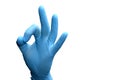 Hand in a blue medical glove, OK sign on a transparent isolated background Royalty Free Stock Photo