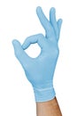 Hand in blue medical glove showing approval ok sign isolated on white background Royalty Free Stock Photo