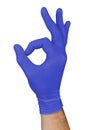 Hand in blue medical glove showing approval ok sign isolated on white background Royalty Free Stock Photo