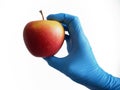 hand in blue medical gloves holding a red apple isolated white background, Healthy food Royalty Free Stock Photo