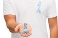 Hand with blue prostate cancer awareness ribbon