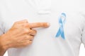 Hand with blue prostate cancer awareness ribbon
