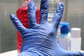 Hand in rubber glove with protection supplys in blurred background