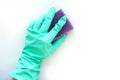 hand in a blue rubber glove with a purple sponge for washing on a white background. Royalty Free Stock Photo