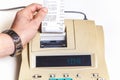 Hand removes check from printing calculator on white background Royalty Free Stock Photo