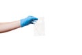 A hand in a blue sterile glove holds an airtight bag with a cotton swab.