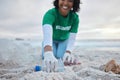 Hand, bottle and a volunteer woman on the beach for community, charity or activism during a clean up. Cleaning