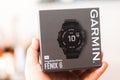 Hand with box of Garmin Fenix 6 Pro smart watch. Unpacking purchase concept. Royalty Free Stock Photo