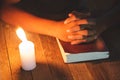 Hand boy praying In the room and lit candles to light , Hands folded in prayer concept for faith, spirituality and religion