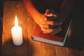 Hand boy praying In the room and lit candles to light , Hands folded in prayer concept for faith, spirituality and religion Royalty Free Stock Photo