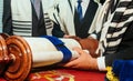 Hand of boy reading the Jewish Torah at Bar Mitzvah