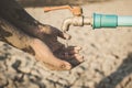 Hand of boy want to drink some water on crack ground Royalty Free Stock Photo