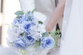 The hand of the bride holding a bouquet of flowers expressing love is a symbol of happiness