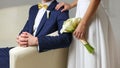 Hand of the bride holds a bouquet of callas