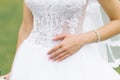 Hand of the bride lying on the wedding white dress, wedding manicure Royalty Free Stock Photo