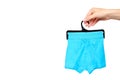 Hand with bright boxer underwear, cotton pants