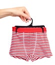 Hand with bright striped boxer underwear. Isolated Royalty Free Stock Photo