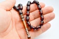Hand and brown beads sequenced, short rosary, tespih tesbih Royalty Free Stock Photo