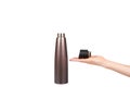 Hand with brown metal thermos, travel mug for hot drinks