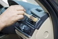 Hand brushing the car dashboard