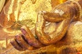 A hand of buddha statue made from square yellow glass.