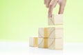 Hand build stairs of wooden block toy on the table