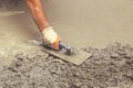 Hand builder with trowel leveling concrete 3