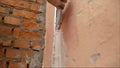 The use of mortar for wall repairs. hand of builder worker use trowel plastering concrete at wall Royalty Free Stock Photo