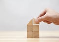 Hand building house with wooden blocks Royalty Free Stock Photo