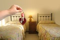 hand with bunch keys against Cozy Beds in Hotel, Serene Sleeping in Twin Beds, Soft Hotel Pillows and Bedding, Rejuvenating Hotel