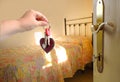 hand with bunch keys against old-fashioned room on sunny day, iron bed filled with bedspread, bright light from window, Room for