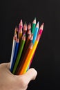 Hand Bundle Pencils On Black Background Close-up Royalty Free Stock Photo