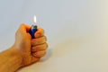 Hand burning a lighter on white background Royalty Free Stock Photo