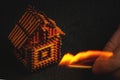 Hand with a burning match sets fire to the house model of matches, risk, property Insurance protection or ignition of combustible Royalty Free Stock Photo