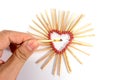 Hand with burning match with shape of heart matches isolated on white background Royalty Free Stock Photo