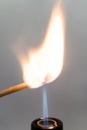 Hand burning match stick. A photo on a gray background. International Day matchstick.